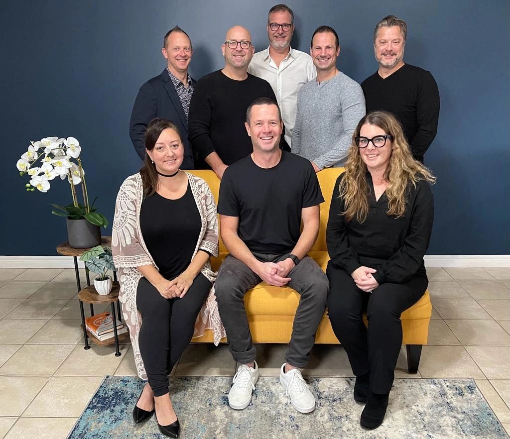 Eight-person team portrait inside an office